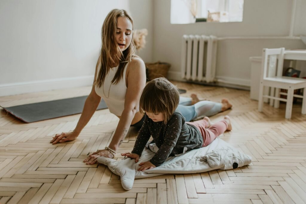 pexels photo 3094230 3094230 A mother and child practicing yoga together at home on a sunny day, fostering wellness and connection.